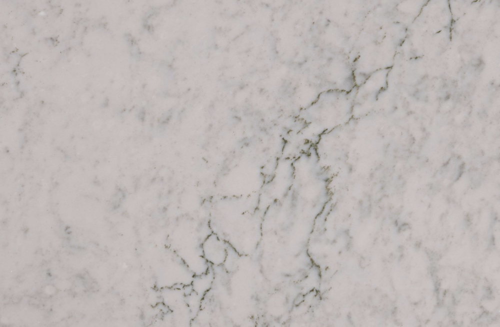 Bridport quartz slab featuring a soft white background and subtle green and grey veining in Northbrook Bridport quartz slab with a soft white background and subtle green and grey veining in Northbrook