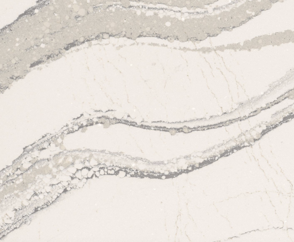 Brittanicca quartz slab featuring a creamy white background with gray islands, intertwining ashen veins, and charcoal speckles in River Forest Brittanicca quartz slab with a creamy white background and gray islands and peninsulas with ashen veins and charcoal speckles in River Forest