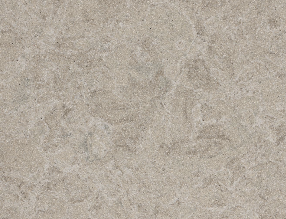 Cambria Buxton quartz with sandy beige tones and gentle taupe and gray speckling in Forest Park Buxton quartz slab featuring a sandy beige background with subtle taupe and gray speckles in Forest Park