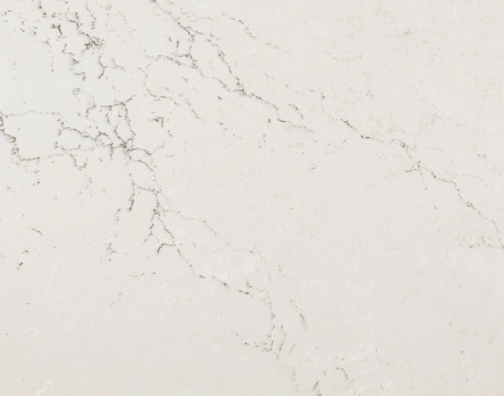 Colton quartz countertop sample with light cream tones and subtle veining in Lisle Colton quartz surface sample with a creamy white background and delicate grey veining in Lisle