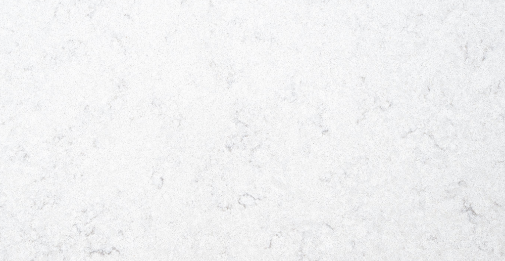 Refined Carrara Iris quartz slab featuring a subtle white base accented by gentle grey marbling, ideal for countertops, vanities and accent walls in Hinsdale Carrara Iris quartz slab with a soft white background and delicate grey marbling, ideal for countertops in Hinsdale homes