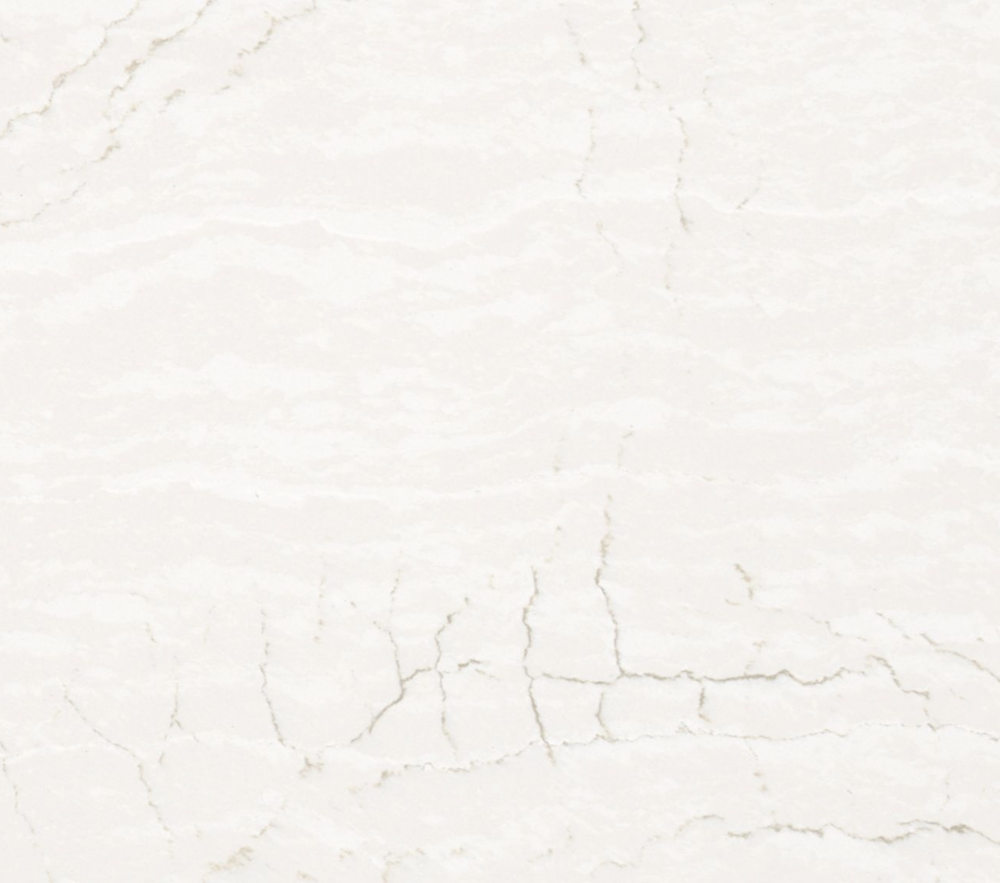Delgatie quartz slab featuring a soft off-white background with subtle cream marbling and crackled veining in Mundelein Delgatie quartz slab with a soft off-white background and subtle cream marbling and crackled veining in Mundelein