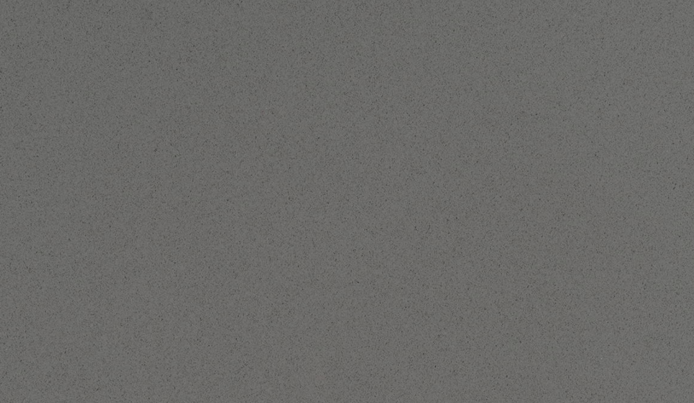 Mystic Gray quartz slab with a smooth cool grey base and fine textured speckles, ideal for contemporary countertops and surfaces in River Forest Mystic Gray quartz slab featuring a cool grey background with subtle texture and speckling, perfect for countertops in River Forest homes
