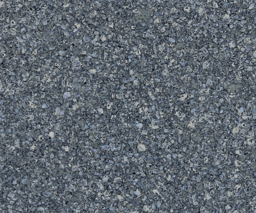 Parys granite slab featuring a deep blue-gray base with scattered quartz-like fragments in Westmont Parys granite slab with a deep blue-gray base and scattered quartz-like fragments in Westmont