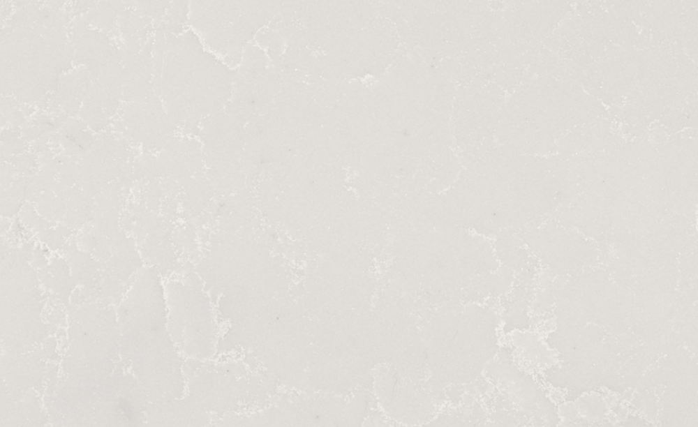 Perla White quartz slab featuring a gentle white base with delicate grey speckles, perfect for countertops and backsplashes in Evanston Perla White quartz slab with a soft white background and subtle grey speckles, ideal for countertops in Evanston homes