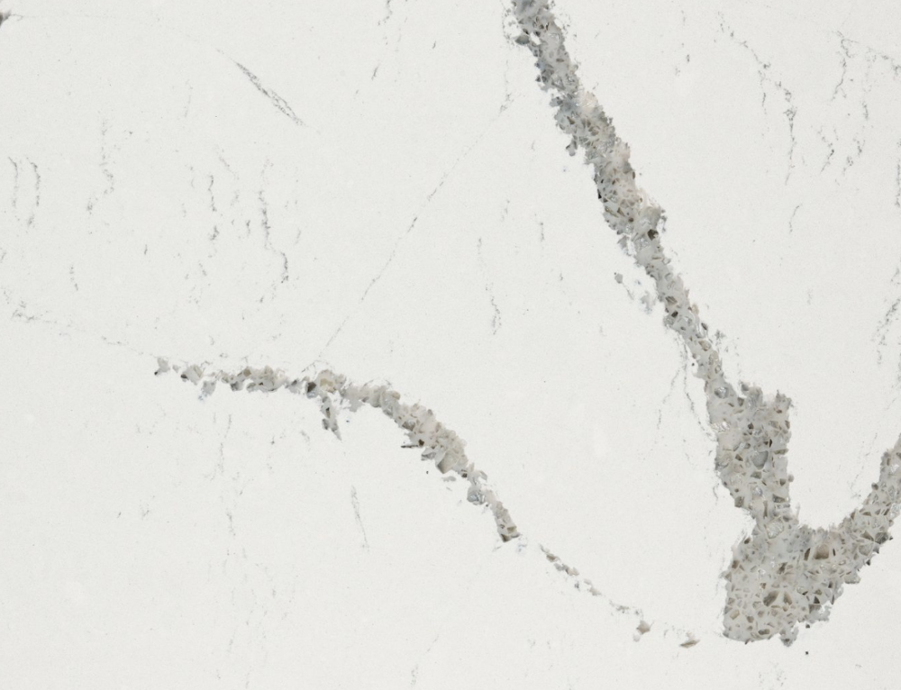 Queensbury quartz slab featuring a clean white background accented by a large grey and taupe vein in Darien Queensbury quartz slab with a clean white background accented by a large grey and taupe vein in Darien