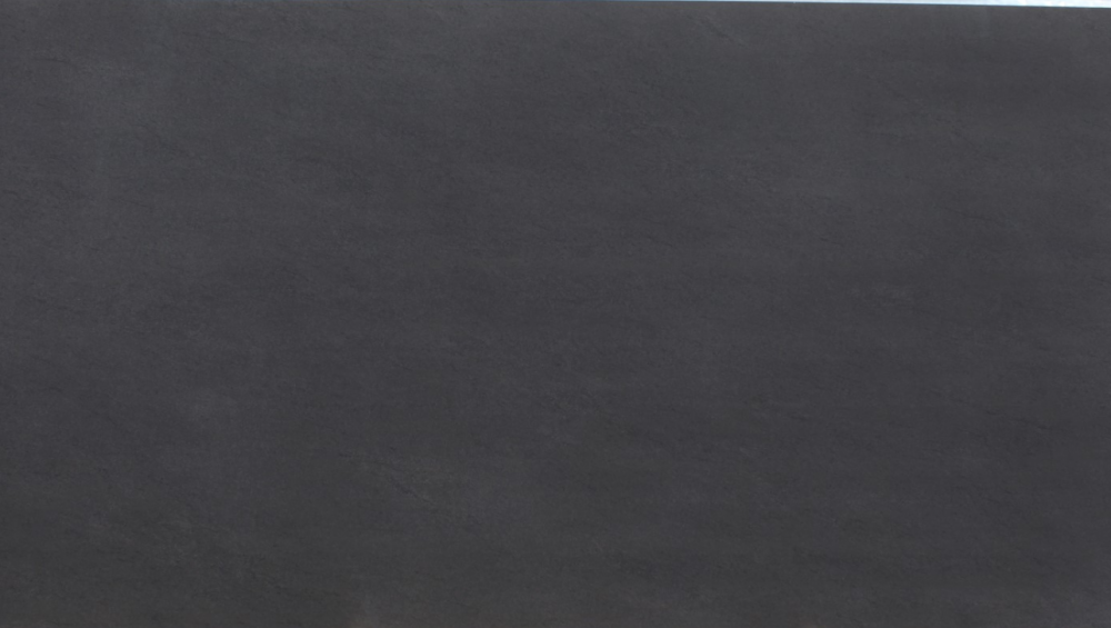 Basalto Dark porcelain slab with deep charcoal tones and subtle speckled texture, perfect for countertops in Skokie homes